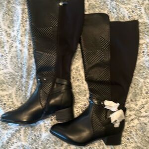 Black boots, silver buckle detailing and with wide calf
